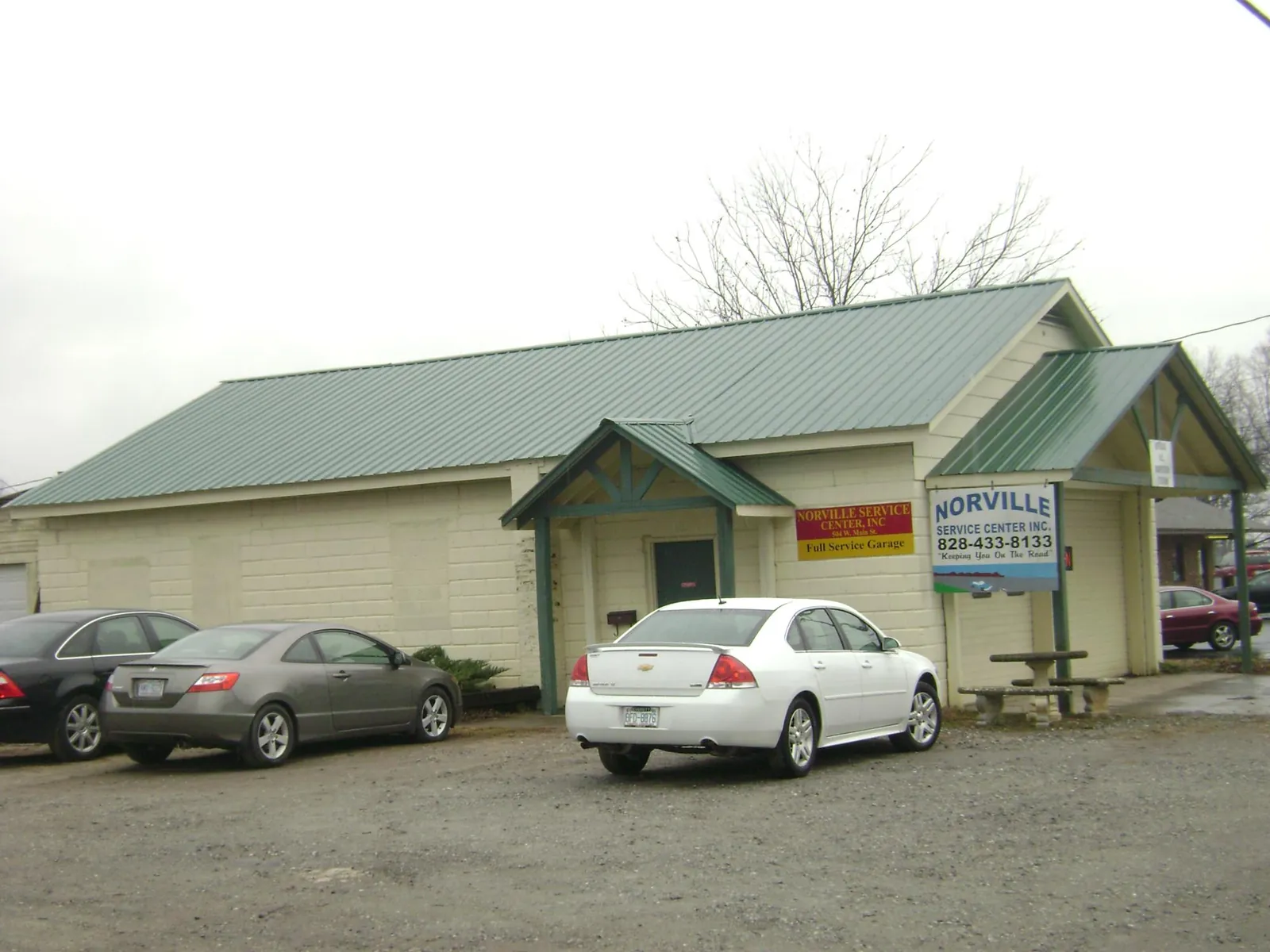 Green metal roof on a service garage with a covered entry in Birmingham